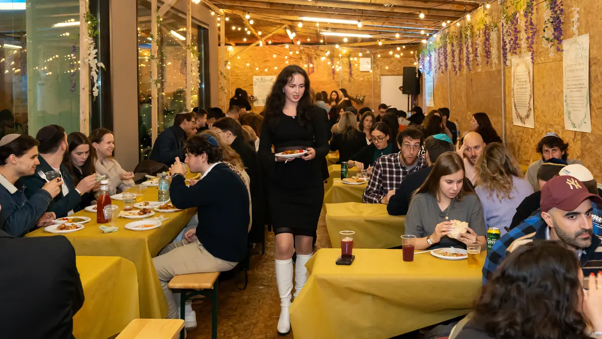 Students eating together in the COCV sukkah